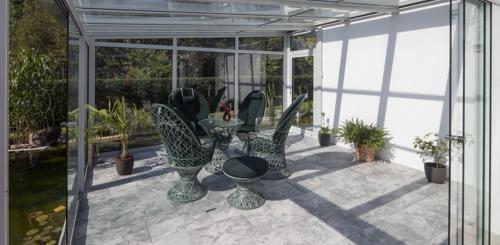 serre aanbouw met schuifpui